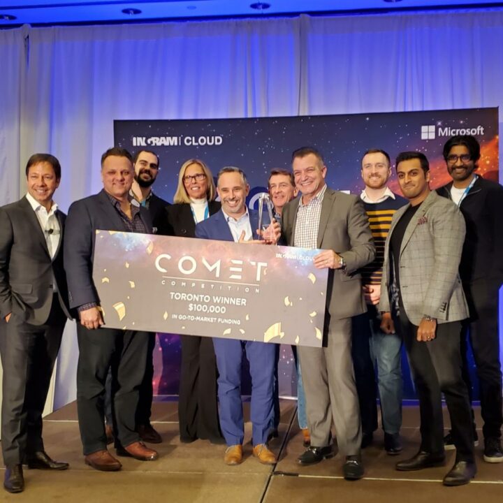 Jay Goldman holding Comet Competition winner's cheque